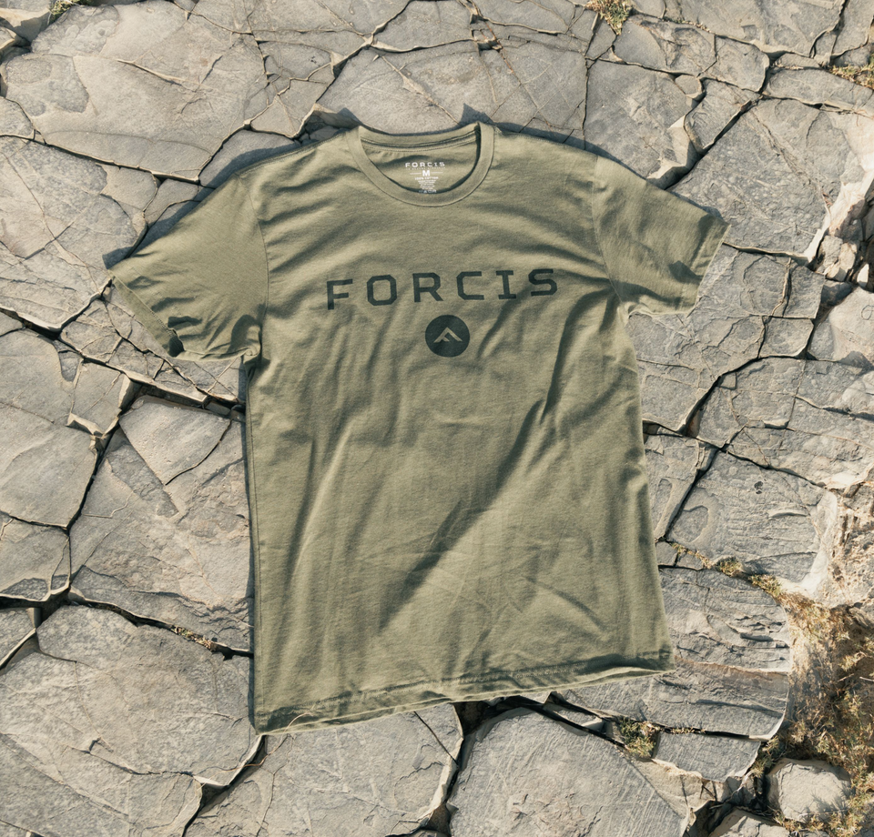T-shirt laid down on a dried rock background.